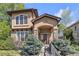 Charming home with stone accents and a well-maintained lawn, showcasing its inviting entrance at 8053 E Maple Ave, Denver, CO 80230