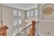 Elegant two-story foyer featuring a decorative chandelier, staircase with iron railings, and lots of natural light at 8053 E Maple Ave, Denver, CO 80230