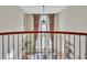 Open-concept foyer featuring a large window with draperies and wrought iron railing at 8053 E Maple Ave, Denver, CO 80230