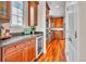 Galley kitchen showcasing granite counters, stainless appliances, and wood floors at 8053 E Maple Ave, Denver, CO 80230