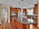 Spacious kitchen island with granite counters, stainless appliances, and wood floors at 8053 E Maple Ave, Denver, CO 80230