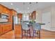 Kitchen with wood cabinets, granite countertops, stainless appliances, and a breakfast bar at 8053 E Maple Ave, Denver, CO 80230