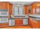 Kitchen featuring stainless steel appliances, wood cabinets, and granite countertops at 8053 E Maple Ave, Denver, CO 80230