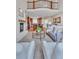 Spacious living room with stone fireplace, leading to the kitchen with a breakfast bar at 8053 E Maple Ave, Denver, CO 80230