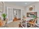 Well-lit office space features a fireplace, hardwood flooring, and open entrance to a bathroom at 8053 E Maple Ave, Denver, CO 80230