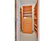 Organized walk-in closet featuring wooden shelves and drawer units, maximizing storage space at 8053 E Maple Ave, Denver, CO 80230