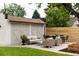 Backyard patio area with new privacy fence, outdoor seating, and lush landscaping at 4261 Julian St, Denver, CO 80211