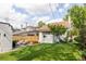 Sprawling backyard featuring a patio, lush lawn, mature trees, and a privacy fence at 4261 Julian St, Denver, CO 80211