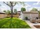 Lush backyard with well-manicured lawn, patio seating, and new privacy fence at 4261 Julian St, Denver, CO 80211