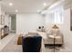 Cozy basement living area with a comfortable sectional sofa, stylish accents, and ample lighting at 4261 Julian St, Denver, CO 80211