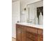 Close-up of the bathroom vanity featuring dark wood cabinets, a white countertop, and gold fixtures at 4261 Julian St, Denver, CO 80211
