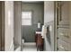 Cozy bathroom with wood vanity, wainscoting, and neutral color palette at 4261 Julian St, Denver, CO 80211