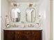 Dual vanity bathroom with marble countertop, wooden cabinets, and stylish lighting fixtures at 4261 Julian St, Denver, CO 80211