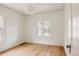 Bright bedroom with hardwood floors, white walls, and a large window providing natural light at 4261 Julian St, Denver, CO 80211
