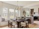 Dining area showcases modern chandelier, ample seating, and open view to the kitchen at 4261 Julian St, Denver, CO 80211