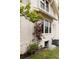 Charming exterior with a blooming rose trellis climbing along a newly painted brick wall at 4261 Julian St, Denver, CO 80211