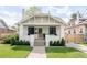 Charming home featuring a brick facade, covered porch, and well-manicured lawn at 4261 Julian St, Denver, CO 80211