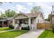 Lovely painted brick home showcasing a well-kept lawn and welcoming front porch at 4261 Julian St, Denver, CO 80211