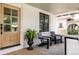 Inviting porch with modern chairs, plants, and beautiful natural wood door at 4261 Julian St, Denver, CO 80211