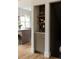 Stylish hallway with a built-in cabinet, decorative wallpaper, and hardwood floors at 4261 Julian St, Denver, CO 80211