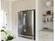 This kitchen showcases a stainless steel refrigerator, white cabinetry, and stylish brass hardware at 4261 Julian St, Denver, CO 80211