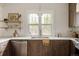 Charming kitchen with wood cabinets, stainless steel appliances, white subway tile, and open shelving at 4261 Julian St, Denver, CO 80211