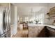 Open-concept kitchen flows into the living space, featuring wood floors and a breakfast bar at 4261 Julian St, Denver, CO 80211