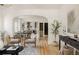 Open-concept living space with stylish furnishings, hardwood floors, and seamless flow to dining area at 4261 Julian St, Denver, CO 80211