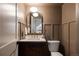 Charming powder room featuring a designer mirror, stylish vanity, and elegant fixtures at 4261 Julian St, Denver, CO 80211