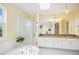 Bright bathroom features a glass-enclosed shower, soaking tub, and a granite vanity with double sinks at 9921 Spring Hill Pl, Highlands Ranch, CO 80129