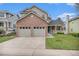 Charming two-story home featuring a brick facade and a well-maintained lawn at 9921 Spring Hill Pl, Highlands Ranch, CO 80129