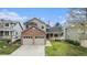 Charming two-story home featuring a brick facade and a well-maintained lawn at 9921 Spring Hill Pl, Highlands Ranch, CO 80129