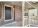 Inviting front porch with brick accents and house number displayed on a column at 9921 Spring Hill Pl, Highlands Ranch, CO 80129