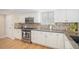 Bright kitchen with stainless steel appliances, granite counters, tile backsplash, and modern cabinetry at 9921 Spring Hill Pl, Highlands Ranch, CO 80129
