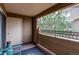 Outdoor balcony with metal railing and view of a tree and building across the way at 4730 Copeland Cir # 204, Highlands Ranch, CO 80126