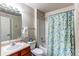 Bathroom featuring single sinks and a shower/tub combination with a blue shower curtain at 4730 Copeland Cir # 204, Highlands Ranch, CO 80126