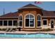 Relax at the community clubhouse pool featuring lounge chairs and manicured landscaping at 4730 Copeland Cir # 204, Highlands Ranch, CO 80126