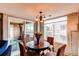 Cozy dining area featuring a wood table, wicker chairs and natural light through a sliding glass door at 4730 Copeland Cir # 204, Highlands Ranch, CO 80126