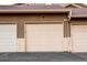 Attached garage with neutral door, matching siding and roofing, and paved driveway at 4730 Copeland Cir # 204, Highlands Ranch, CO 80126
