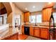 Charming kitchen area with light wood cabinets, stone countertops, and an adjacent dining area at 4730 Copeland Cir # 204, Highlands Ranch, CO 80126