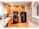 Bright kitchen showcasing wood cabinets, granite counters and black appliances at 4730 Copeland Cir # 204, Highlands Ranch, CO 80126