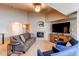 Inviting living room with a cozy fireplace, TV, and comfortable seating at 4730 Copeland Cir # 204, Highlands Ranch, CO 80126