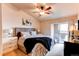 Inviting main bedroom with neutral tones, ceiling fan, and access to outdoor balcony at 4730 Copeland Cir # 204, Highlands Ranch, CO 80126