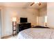 Spacious primary bedroom featuring a ceiling fan, tv, and dresser at 4730 Copeland Cir # 204, Highlands Ranch, CO 80126