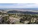 Stunning aerial view of a beautiful property surrounded by trees, open space, and distant mountain views at 25392 Westridge Rd, Golden, CO 80403
