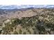 Panoramic aerial view showcasing a house surrounded by lush greenery and mountains at 25392 Westridge Rd, Golden, CO 80403