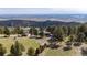 Expansive property with multiple homes, surrounded by lush greenery and breathtaking mountain views at 25392 Westridge Rd, Golden, CO 80403