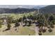 Aerial view displays the property's private driveway and multiple outbuildings within the mountainous landscape at 25392 Westridge Rd, Golden, CO 80403