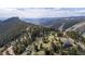 Stunning aerial view of the property nestled among lush forests and rolling hills at 25392 Westridge Rd, Golden, CO 80403