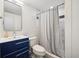 Cozy bathroom featuring a blue vanity, modern fixtures, and shower with stylish curtain at 25392 Westridge Rd, Golden, CO 80403